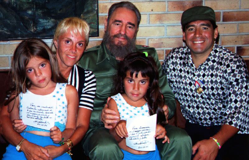 FILE PHOTO: Cuban President Fidel Castro poses with Argentine soccer star Diego Maradona, his wife Claudia Villa..