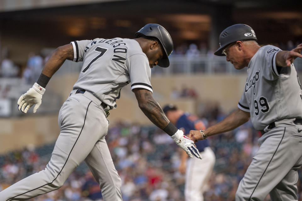 Chicago White Sox Tim Anderson, left, celebrates with third base coach Joe McEwing after hitting a solo home run against the Minnesota Twins during the fourth inning of a baseball game Friday, July 15, 2022, in Minneapolis. (AP Photo/Craig Lassig)