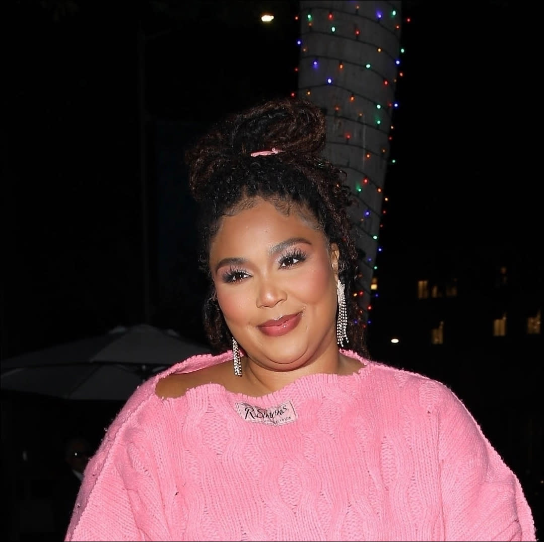  Lizzo in a pink sweater dress . 