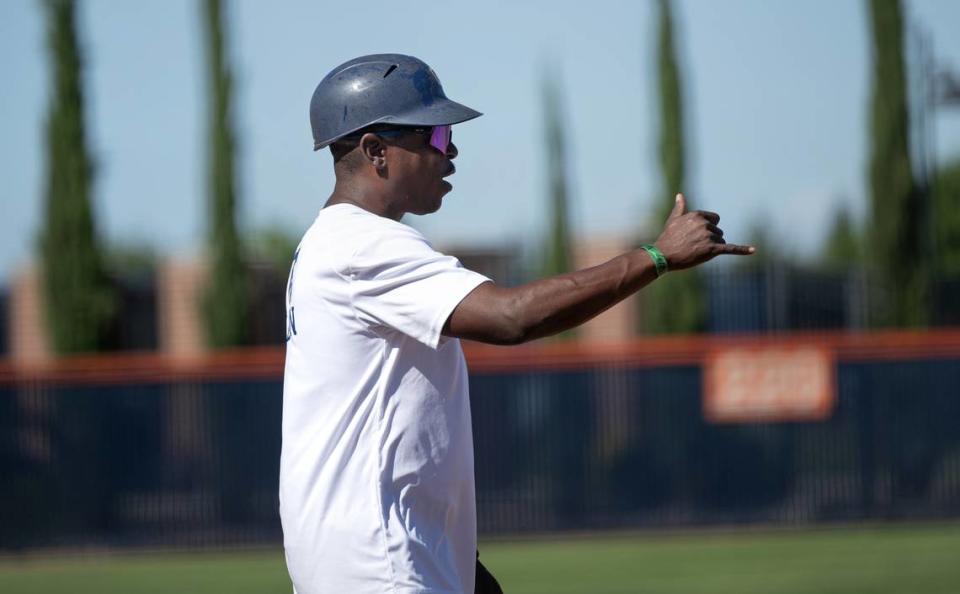 Central Cathloic coach Sam Nichols signals to a runner on first during the Sac-Joaquin Section D IV softball championship game with Dixon at Cosumnes River College in Sacramento, Calif., Saturday, May 25, 2024.