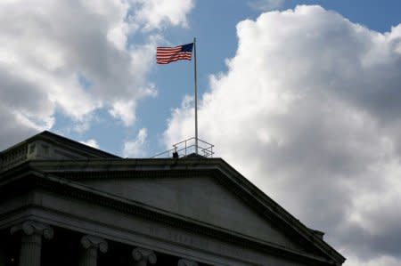 FILE PHOTO: The United States flag flies atop the U.S. Treasury Department in Washington November 18, 2008.   REUTERS/Jim Bourg/File Photo