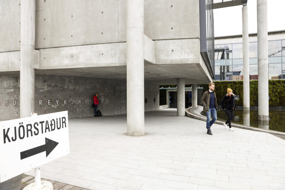 People leave a polling station in Reykjavik, Iceland, Saturday, Sept. 25, 2021. Iceland is heading to the polls for general elections on Saturday with nine parties running for seats at the North Atlantic island nation's Parliament, or Althing. Polls suggest Prime Minister Katrin Jakobsdottir's Left Green Party could face a poor outcome, ending the current coalition. (AP Photo/Brynjar Gunnarsson)