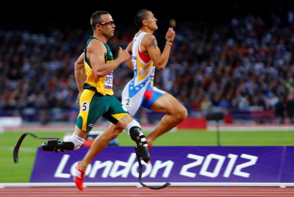 PHOTO: In this file photo, South Africa's Oscar Pistorius runs beside Venezuela's Albert Bravo in the men's 400m semi-final during the London 2012 Olympic Games at the Olympic Stadium August 5, 2012.  (Michael Dalder/Reuters)