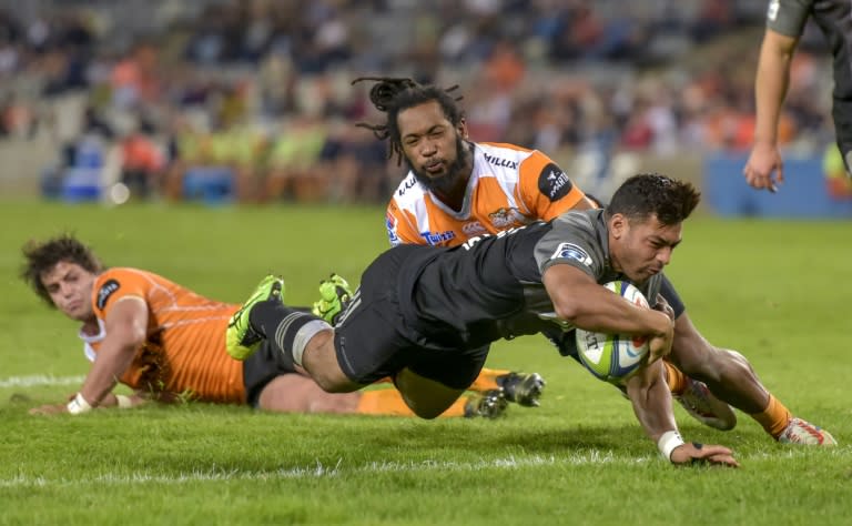 Cheetahs' Francois Venter (back) and Sergeal Petersen (L) fail to stop Crusaders' Richie Mo'unga from scoring a try during the SUPERXV rugby union match between The Cheetahs and The Crusaders in Bloemfontein on April 29, 2017