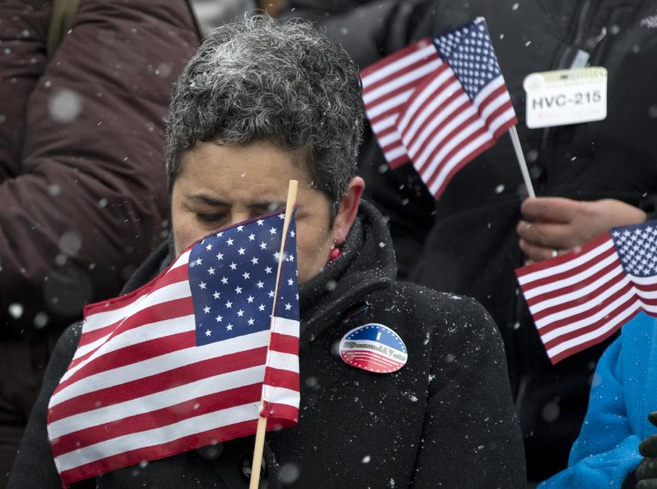 Clarissa Martinez de Castro, director of civic engagement and immigration at the National Council of La Raza (NCLR), closes her eyes as snow falls and wind blows during a news conference with House Democrats and immigration leaders on the steps of the Capitol in Washington, Wednesday, March 26, 2014, to announce a DemandAVote discharge petition and call on House Speaker John Boehner of Ohio, and the House Republican Conference to bring up immigration reform bill H.R. 15. (AP Photo/Carolyn Kaster)