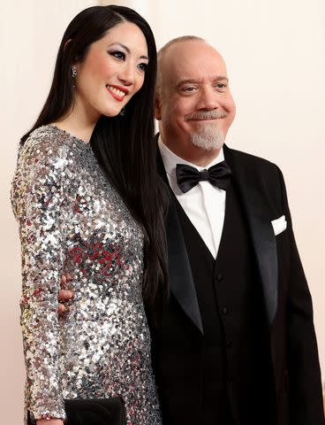 <p>Arturo Holmes/Getty</p> Clara Wong and Paul Giamatti at the 2024 Oscars