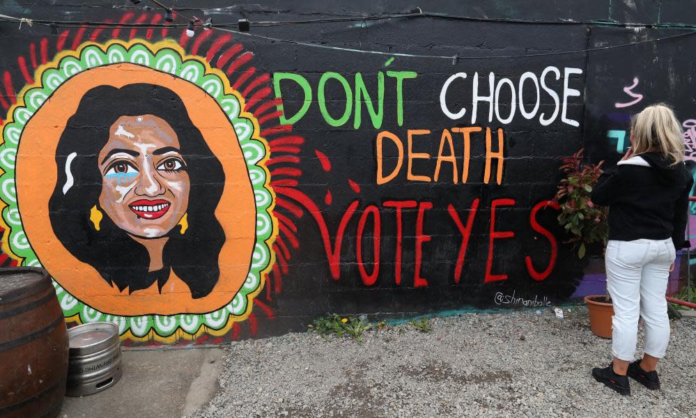 A woman looks at a pro-choice mural in Dublin featuring Savita Halappanavar.