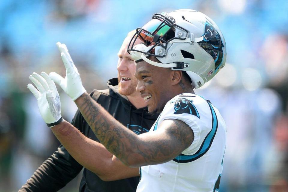 Carolina Panthers wide receiver DJ Moore, right, and offensive coordinator Joe Brady, left, speak prior to the season opener game against the New York Jets at Bank of America Stadium in Charlotte, NC on Sunday, September 12, 2021.