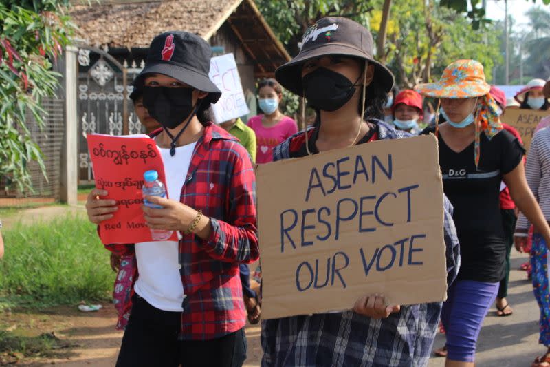 People attend a protest against Myanmar's military coup in Launglon