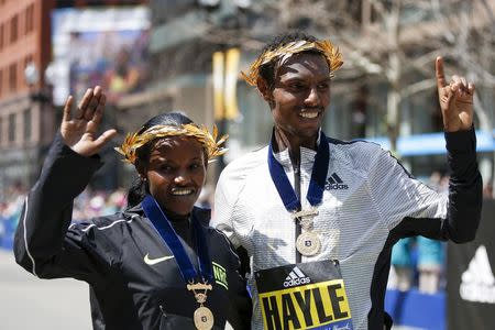 Apr 18, 2016; Boston, MA, USA; Atsede Baysa and Lemi Berhanu Hayle both from Ethiopia pose for a photograph after winning the 120th Boston Marathon. Mandatory Credit: Greg M. Cooper-USA TODAY Sports