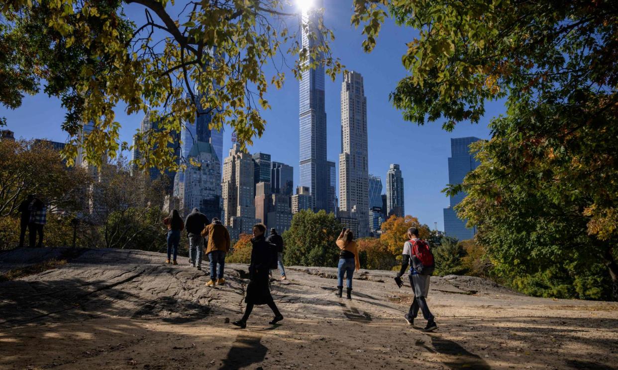 <span>People in Central Park, New York. The city is one of several on the US east coast at risk of flooding.</span><span>Photograph: Ed Jones/AFP/Getty Images</span>