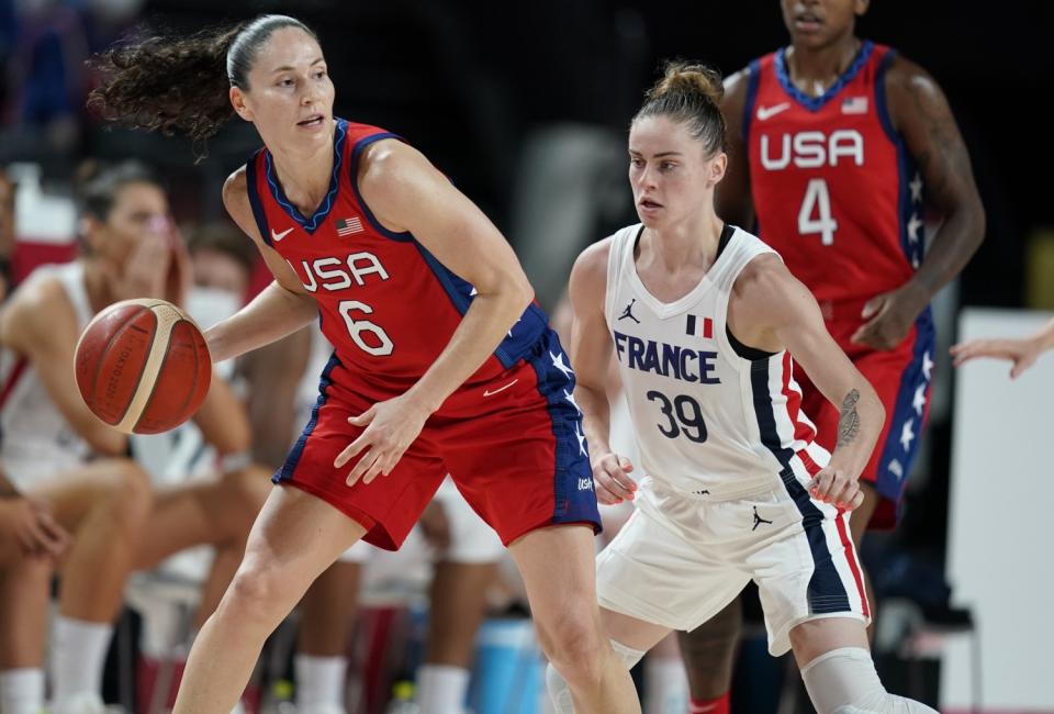 Sue Bird and Alix Duchet vie for the ball.