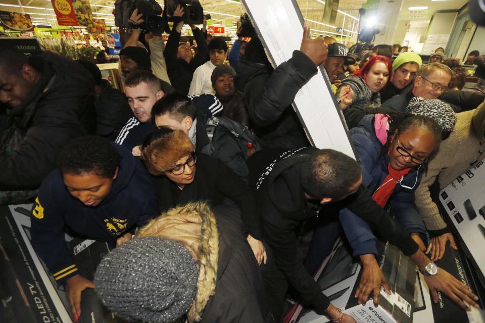 Shoppers compete to purchase retail items on "Black Friday" at an Asda superstore in Wembley