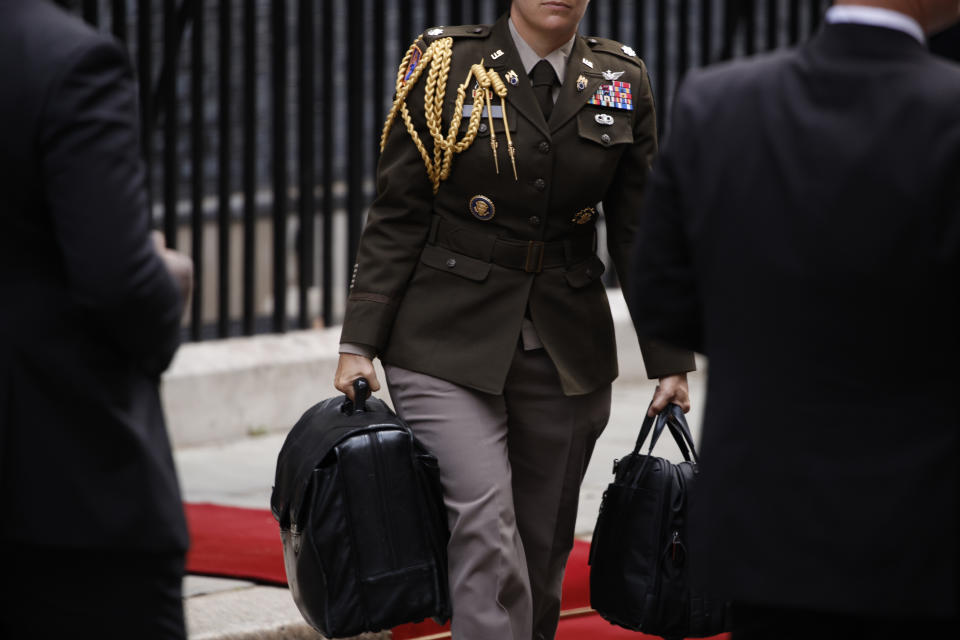 A military aide carries the Presidential Emergency Satchel, also known as the "nuclear football," out of 10 Downing Street in London on Monday, July 10, 2023, after a meeting between Prime Minister Rishi Sunak and U.S. President Joe Biden. The bulky briefcase contains atomic war plans and enables the president to transmit nuclear orders to the Pentagon. The heavy case is carried by a military officer who is never far behind the president. (AP Photo/David Cliff)