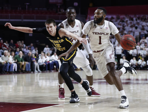 Temple’s Josh Brown, right, drives to the basket against Wichita State’s Austin Reaves, left, during the second half of an NCAA basketball game, Thursday, Feb. 1, 2018, in Philadelphia. Temple won 81-79 in overtime. (AP Photo/Chris Szagola)