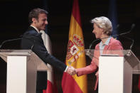 French President Emmanuel Macron, left, shakes hands with the president of the European Commission Ursula von der Leyen during the H2Med summit Mediterranean summit in Alicante, Spain, Friday Dec. 9, 2022. The H2Mad summit is to discuss a plan for an undersea pipeline that would eventually transport hydrogen and will connect the ports of Barcelona in Spain and Marseille in France. (AP Photo/J.M Fernandez)