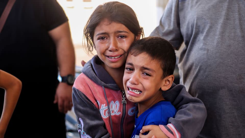 Children cry because of Israeli strikes on the city of Khan Younis, in southern Gaza, on October 15. Palestinian mothers told CNN they cannot protect their kids from the terror of Israel's persistent bombardment. - Ahmad Hasaballah/Getty Images