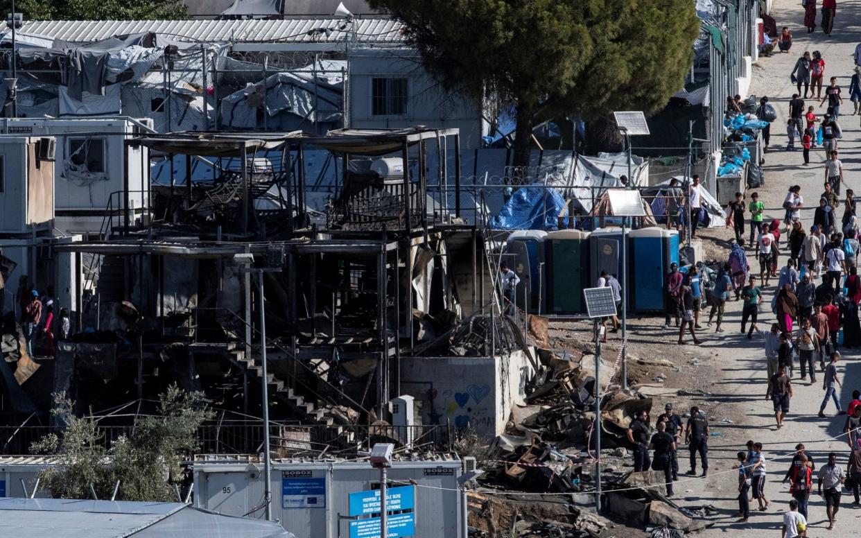 Several accommodation containers were destroyed by the fire at Moria camp - REUTERS