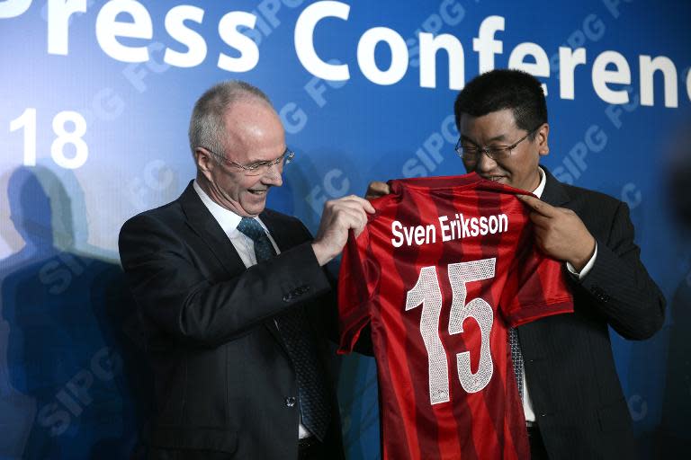 Former England's manager Sven-Goran Eriksson gets his new uniform during a news conference by Chinese Super League (CSL) club Shanghai East Asia, in Shanghai, on November 18, 2014