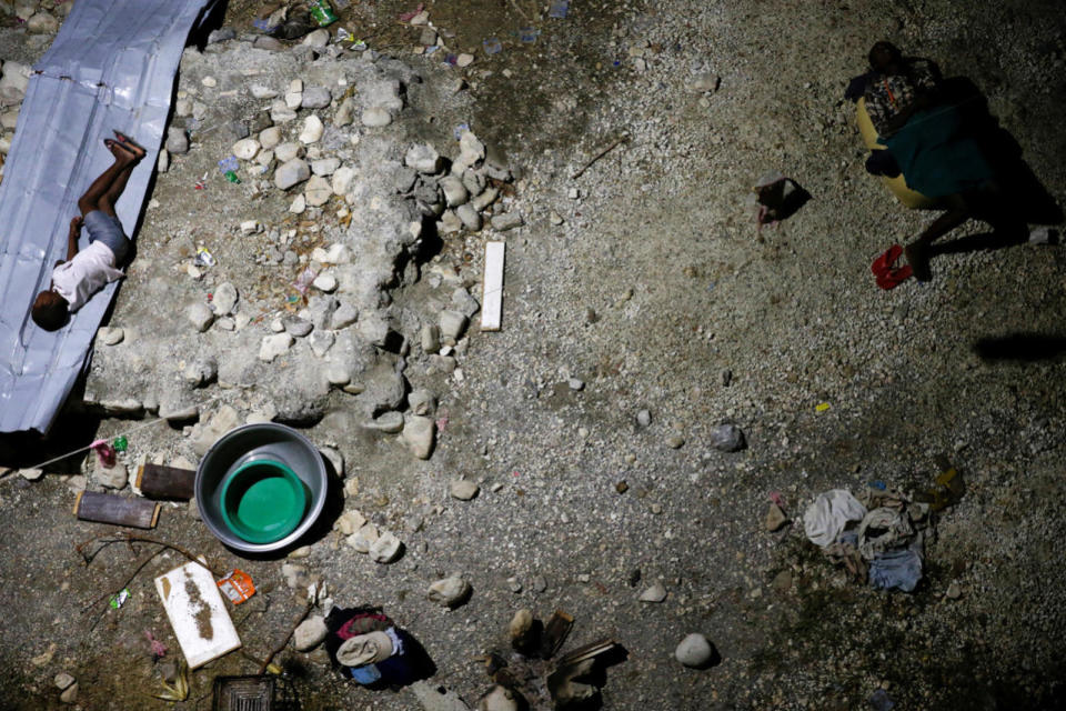 <p>People sleep on the ground in a partially destroyed school used as a shelter after Hurricane Matthew hit Jeremie, Haiti, October 11, 2016. (Carlos Garcia Rawlins/Reuters)</p>