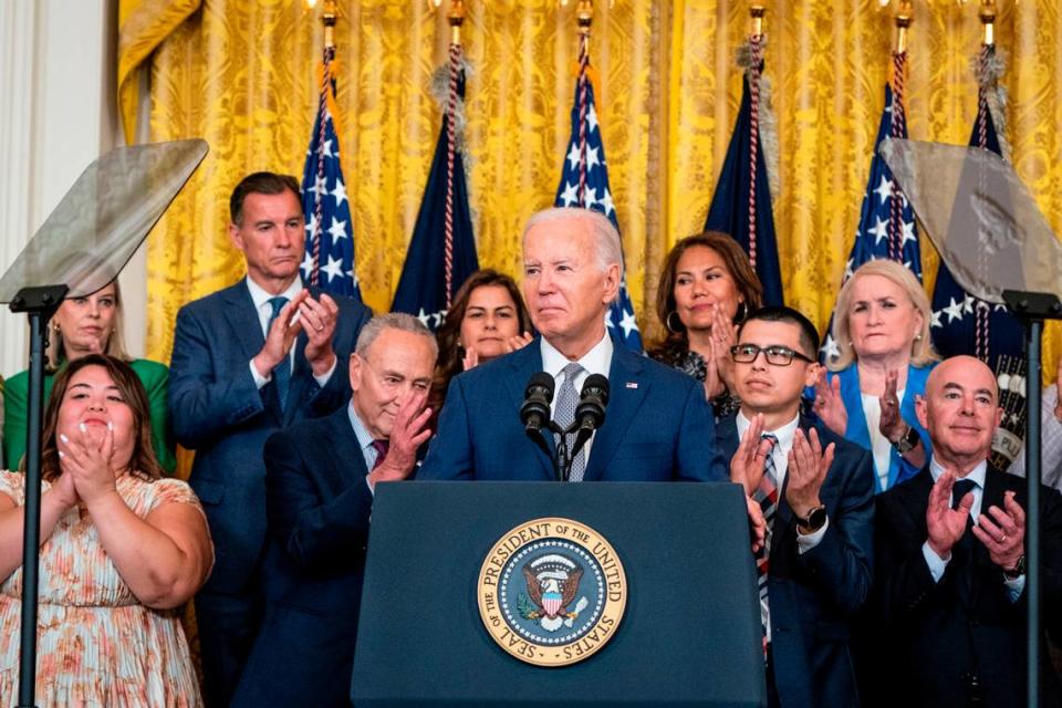 President Joe Biden, with lawmakers and border community members behind him, hosts a 12-year-anniversary event for Deferred Action for Childhood Arrivals on June 18 at the White House. (Haiyun Jiang/The New York Times)