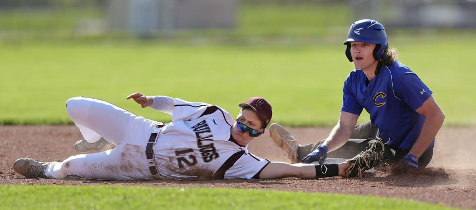 Woodridge shortstop Will Schmeltzer, left, misses a diving tag as Coventry base runner Keo Plant slides safely to second base during the first inning of a baseball game on Monday.