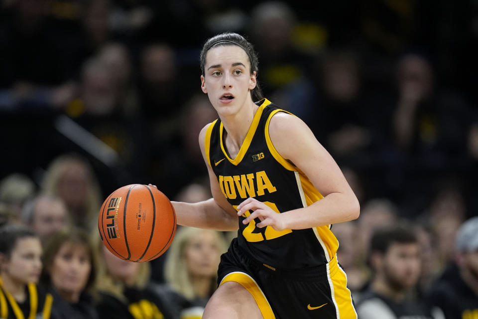 A fan knocked Caitlin Clark down while storming the floor, then ran to join the celebration at midcourt after Ohio State upset No. 2 Iowa. (AP Photo/Charlie Neibergall)