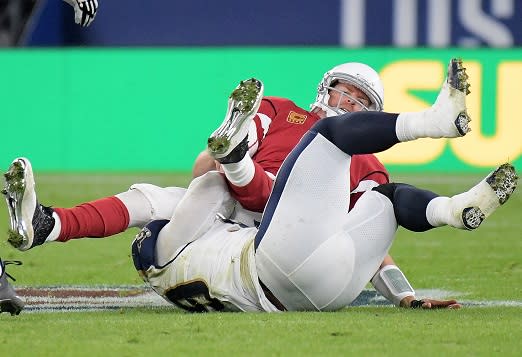 Oct 22, 2017; London, United Kingdom; Arizona Cardinals quarterback Carson Palmer (3) is sacked by Los Angeles Rams defensive end Aaron Donald (99) in the second quarter during an NFL International Series game at Twickenham Stadium. Mandatory Credit: Kirby Lee-USA TODAY Sports