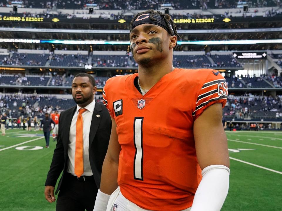 Justin Fields looks up as he walks off the field after a game.