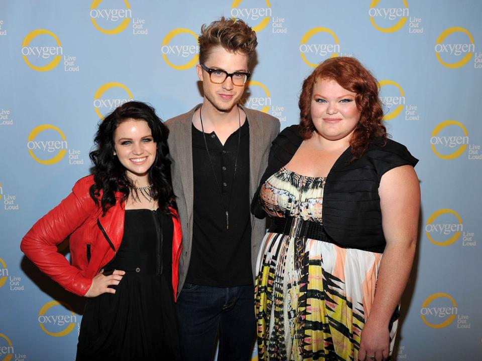 Lindsay Pearce, Cameron Mitchell and Hannah McIalwain posing in front of "Glee Project" background.