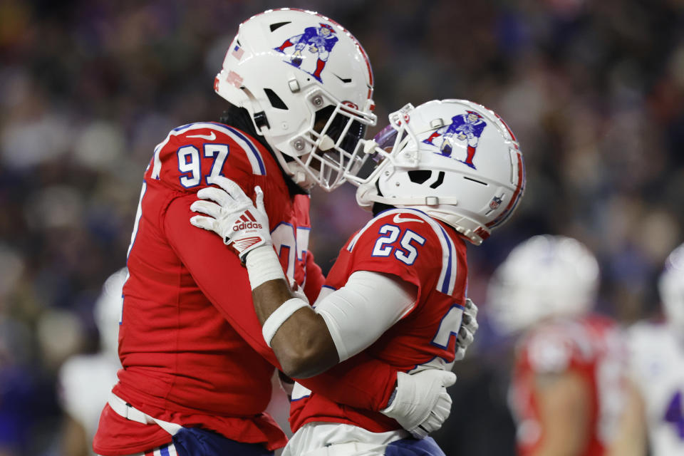 New England Patriots' Marcus Jones (25) is embraced by DaMarcus Mitchell (97) after his touchdown run during the first half of an NFL football game, Thursday, Dec. 1, 2022, in Foxborough, Mass. (AP Photo/Michael Dwyer)