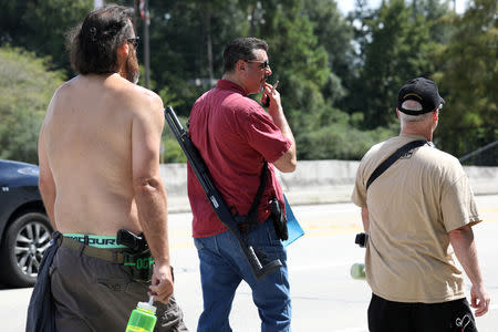 (From L) Open Carry Texas members Joseph Walker and David Amad openly carry firearms with Open Carry Texas founder C.J. Grisham in Houston, Texas, U.S., September 24, 2018. Picture taken September 24, 2018. REUTERS/Loren Elliott