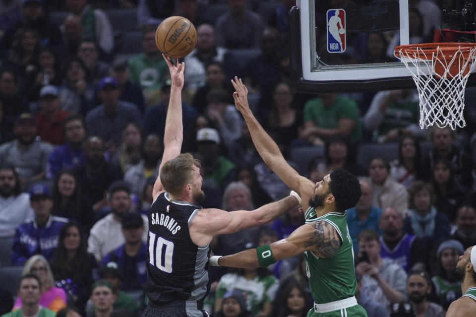 Sacramento Kings forward Domantas Sabonis (10) shoots over Boston Celtics forward Jayson Tatum during the first quarter of an NBA basketball game in Sacramento, Calif., Tuesday, March 21, 2023. (AP Photo/Randall Benton)