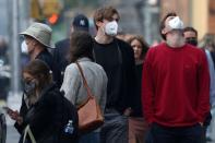 People wear protective face masks as haze and smoke from Canadian wildfires continues to linger in New York