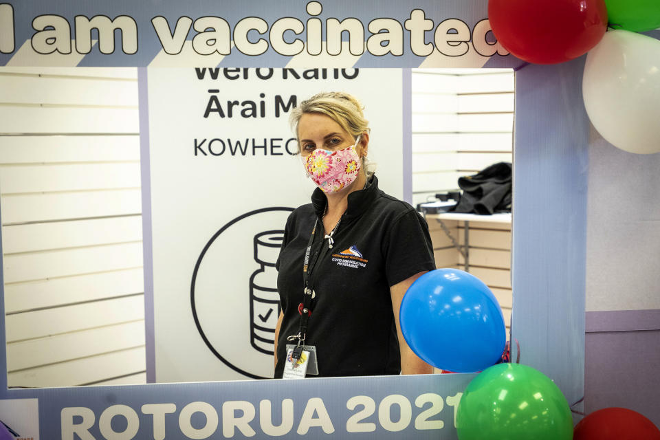 Heather Lang stands at a vaccination center in Rotorua, New Zealand, Saturday, Oct. 16, 2021. New Zealand health care workers have administered a record number of vaccine jabs as the nation holds a festival aimed at getting more people inoculated against the coronavirus. (Andrew Warner/NZME via AP)