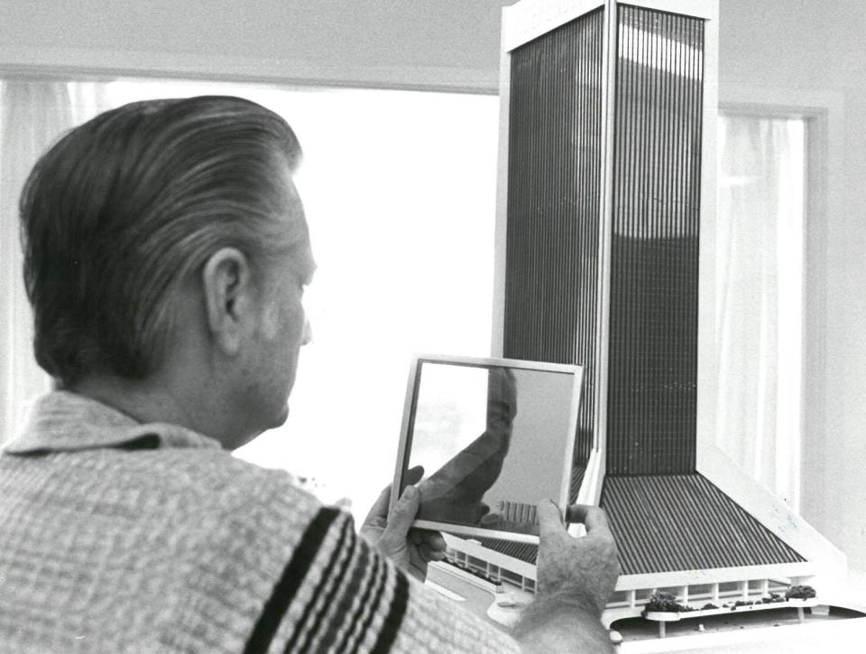 Dec. 22, 1973: An unidentified man holds a glass sample in front of a scale model of the Independent Life Building (now the Wells Fargo Center).