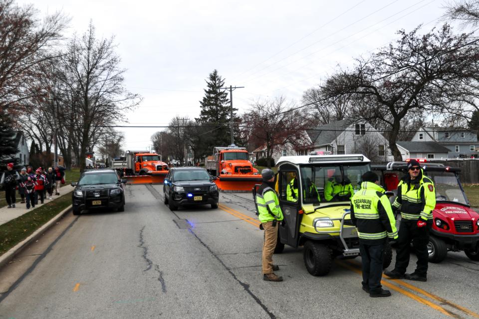 Snowplows from Grafton, Cedarburg and Saukville prevent cars from coming into the 2021 Grafton Christmas Parade.