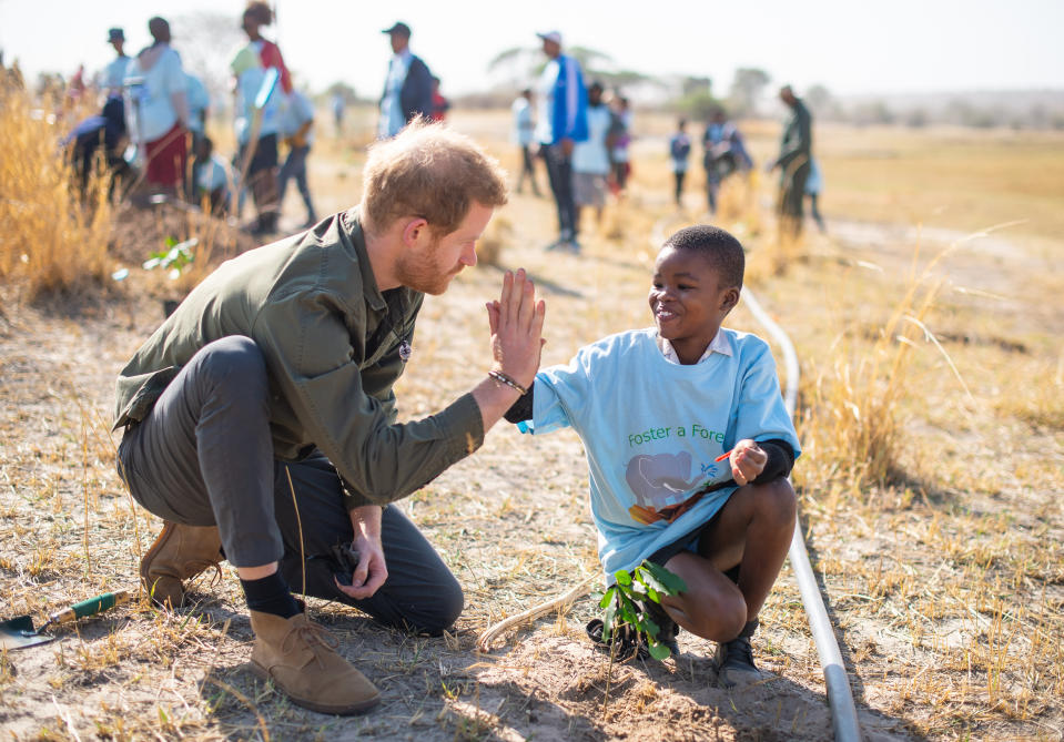 The Duke of Sussex joins in a tree planting event with local children, at the Chobe National Park, Botswana.