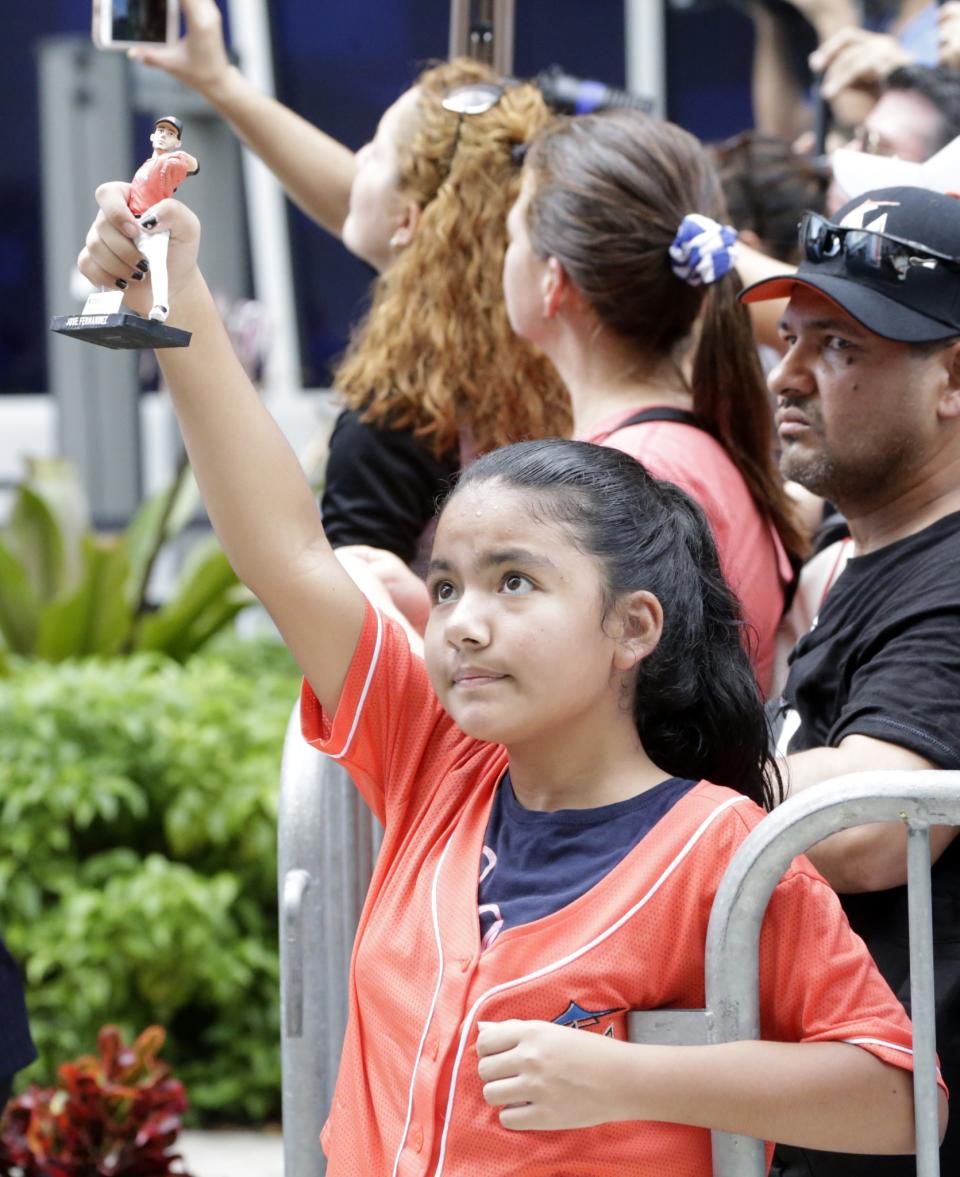 <p>A young girl holds a figurine of Miami Marlins pitcher Jose Fernandez as a hearse carrying his body arrives Marlins Park stadium, Wednesday, Sept. 28, 2016, in Miami. Fernandez, was killed in a weekend boat crash along with two friends. (AP Photo/Wilfredo Lee) </p>