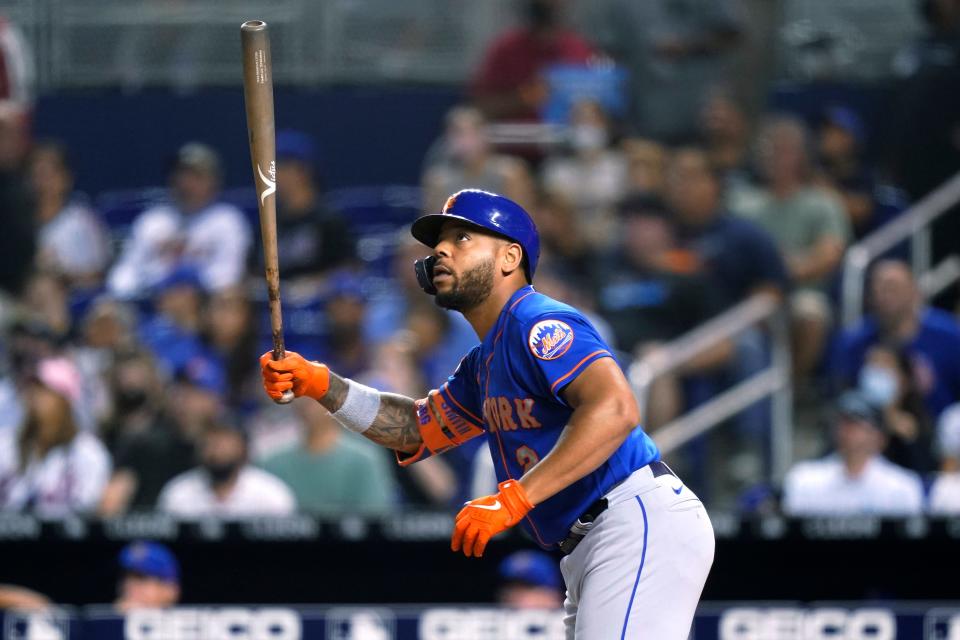 New York Mets' Dominic Smith watches his RBi sacrifice fly during the fourth inning of the team's baseball game against the Miami Marlins, Tuesday, Aug. 3, 2021, in Miami. (AP Photo/Lynne Sladky)