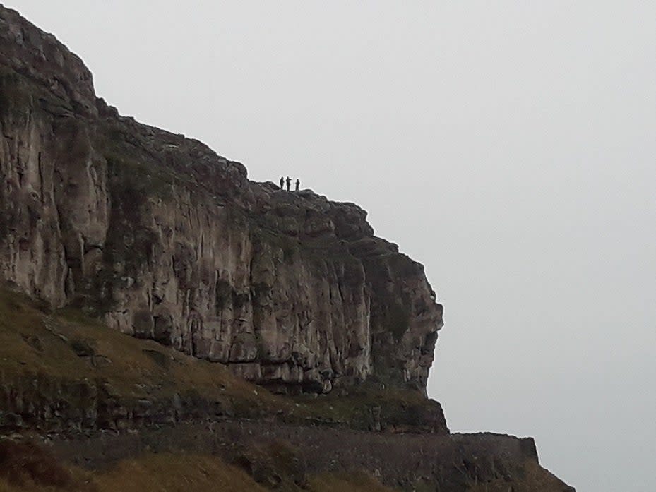 RSPCA officers had to abseil down the cliff and put the sheep in a bag before pulling it to safety (PA)