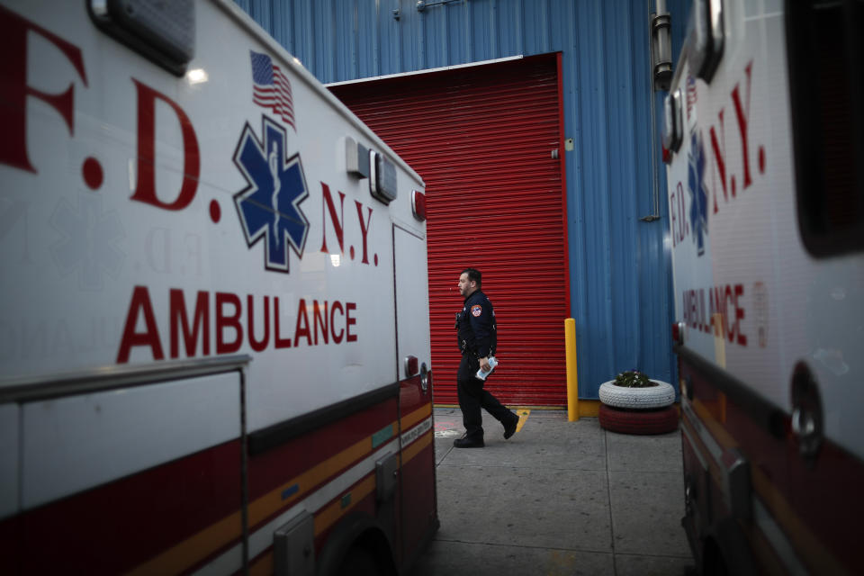 In this April 23, 2020, photo FDNY paramedic Alex Tull, who has recently recovered from COVID-19, prepares to begin his shift outside EMS station 26, the "Tinhouse", in the Bronx borough of New York. (AP Photo/John Minchillo)