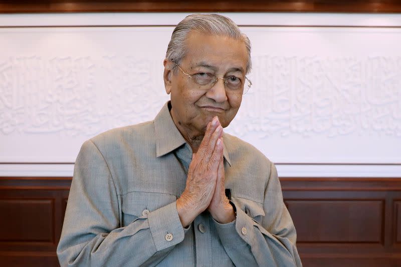 Malaysia's former PM Mahathir gestures after an interview in Kuala Lumpur