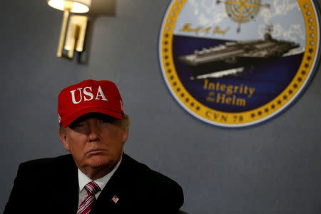 President Trump gets a briefing before he tours the pre-commissioned U.S. Navy aircraft carrier Gerald R. Ford. REUTERS/Jonathan Ernst