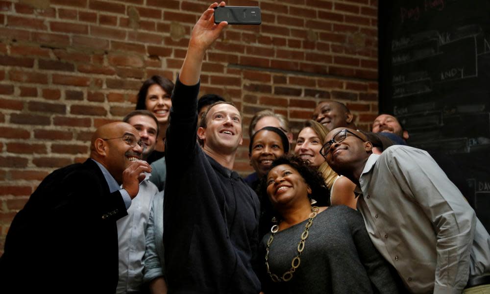 Facebook CEO Mark Zuckerberg poses for a selfie with a group of entrepreneurs