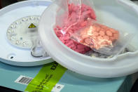 Ecstasy pills that were hidden in a ceiling light fixture are displayed at the U.S. Customs and Border Protection overseas mail inspection facility at Chicago's O'Hare International Airport Feb. 23, 2024, in Chicago. The explosive growth of cross-border e-commerce involving major China-backed players such as Shein and Temu has caught the attention of the U.S. lawmakers amid a bitter U.S.-China trade war and cast a spotlight on a tax rule that critics say has allowed hundreds of millions of China-originated packages to enter the U.S. market each year without duty and without reliable information for lawfulness. (AP Photo/Charles Rex Arbogast)