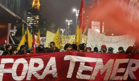 Demonstrators attend a protest against Brazil's President Michel Temer in Sao Paulo, Brazil, May 18, 2017. The sign reads: "Out Temer." REUTERS/Paulo Whitaker