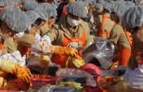 SEOUL, SOUTH KOREA - NOVEMBER 15: More than two thousands of housewives make Kimchi for donation to the poor in preparation for winter in front of City Hall on November 15, 2012 in Seoul, South Korea. Kimchi is a traditional Korean dish of fermented vegetables usually mixed with chili and eaten with rice or served as a side dish to a main meal. (Photo by Chung Sung-Jun/Getty Images)