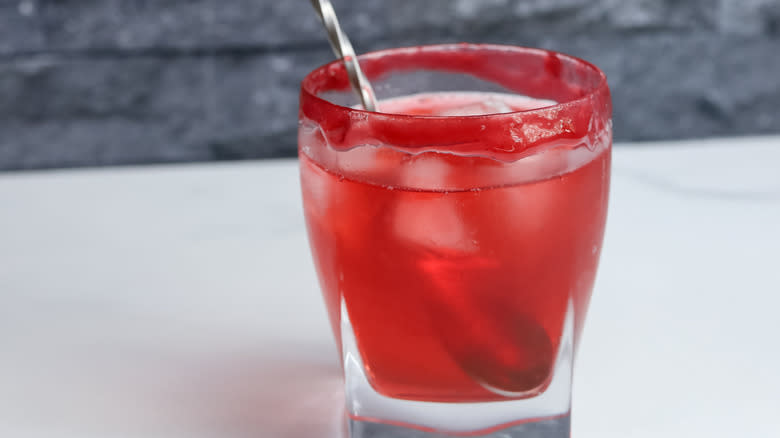 stirring raspberry cocktail ingredients