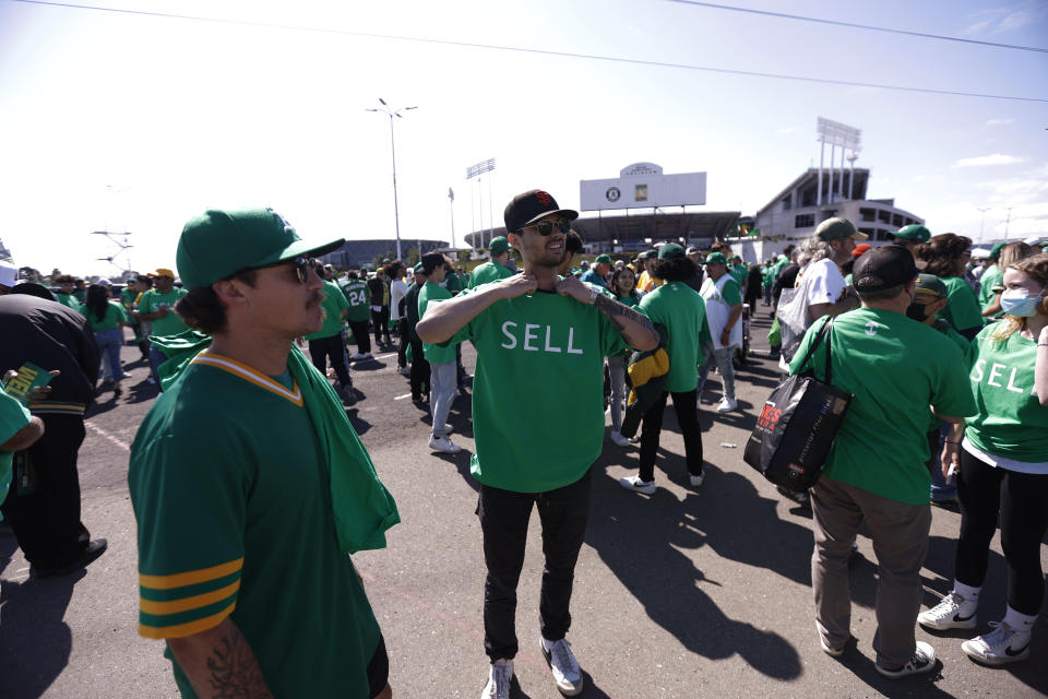 Fans stand outside Oakland Coliseum to protest the Oakland Athletics' planned move to Las Vegas, before a baseball game between the Athletics and the Tampa Bay Rays in Oakland, Calif., Tuesday, June 13, 2023. (AP Photo/Jed Jacobsohn)